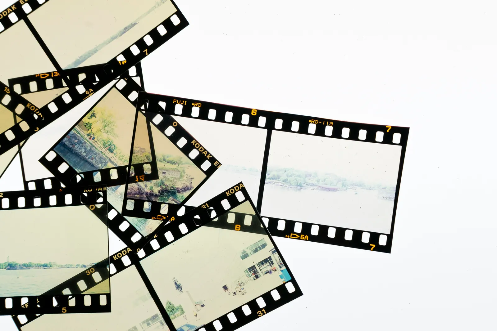 Strips of old photo film spread out on a white table.