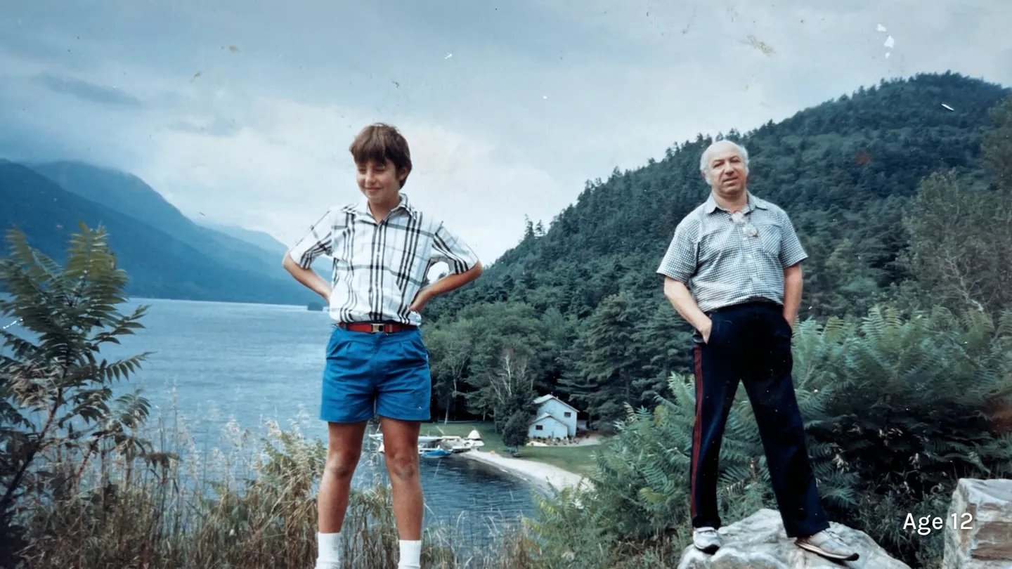 A frame from a finished film: Dimitri as a boy by a lake, with Age 12 in the bottom corner.